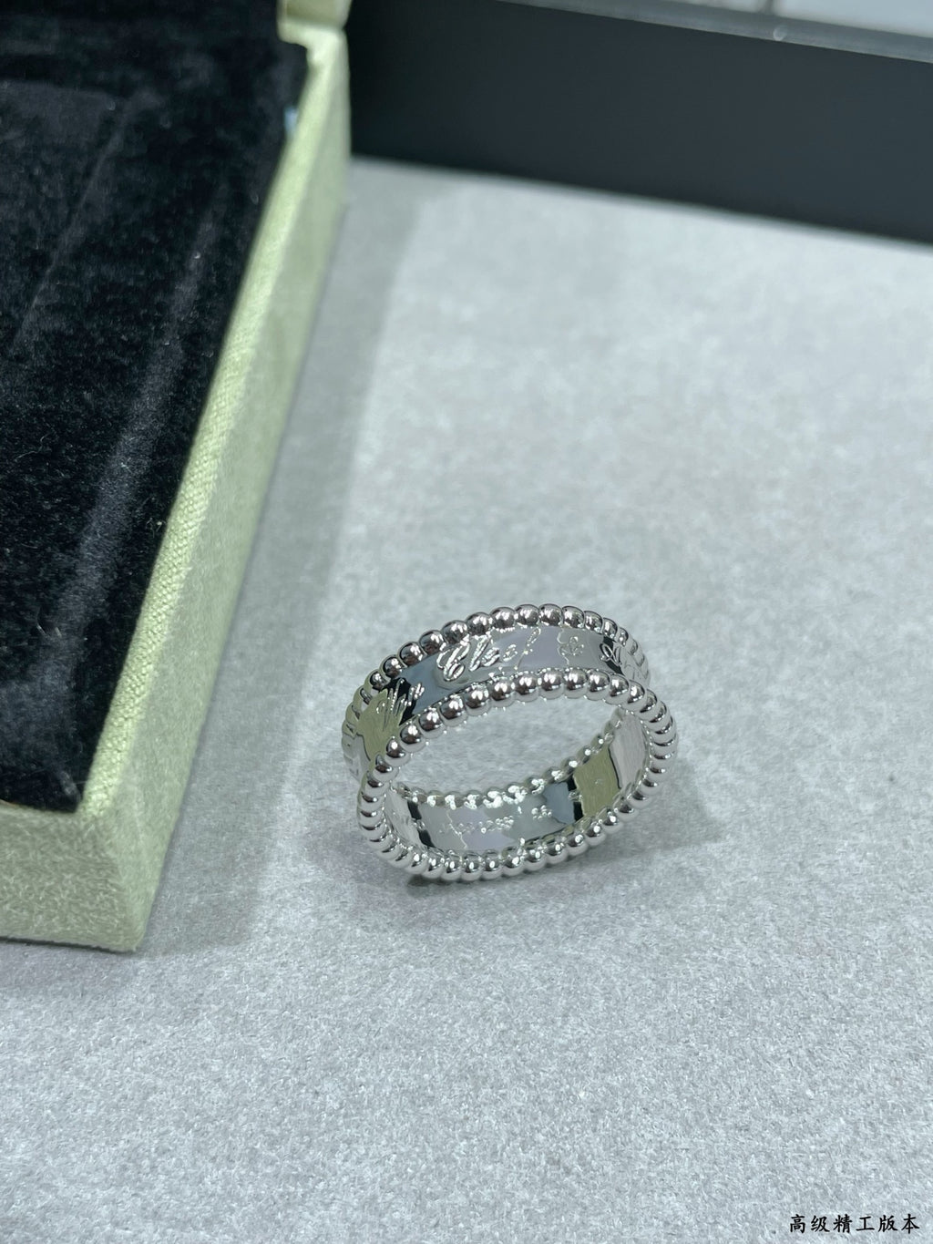 Van Cleef & Arpels silver band ring with scalloped edge and small stones on display