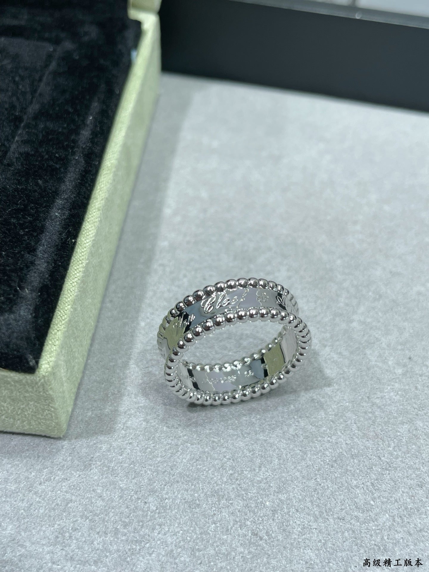 Van Cleef & Arpels silver band ring with scalloped edge and small stones on display