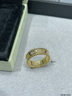 Van Cleef & Arpels gold band ring with scalloped edge and small stones on display