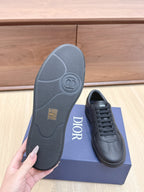 Black sneaker outsole and lace-up low-top shoe with Dior logo on tongue