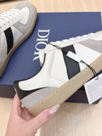 Close-up of white high-top sneaker upper with black side panel and lace tag.