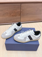 Pair of white and gray lace-up sneakers with black heel and diagonal side panel.