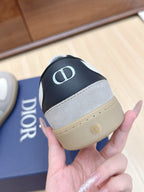 Close-up of sneaker heel in black and gray with Dior-style CD emblem.