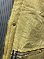 Long quilted coat zipper close-up with plaid lining