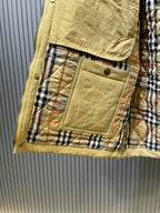 Yellow jacket with plaid-lined interior pocket and stitched trim, buttoned opening.