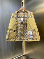Yellow jacket open to reveal plaid lining with Burberry branding at center.