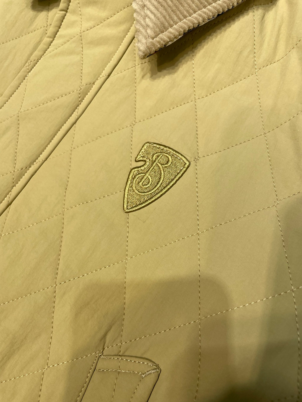 Long quilted coat chest logo patch with diamond quilting and zipper front