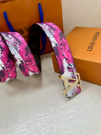 Louis Vuitton belt with pink floral strap and silver LV buckle, folded end view.