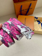 Louis Vuitton belt with pink floral canvas strap and silver LV buckle, close-up.