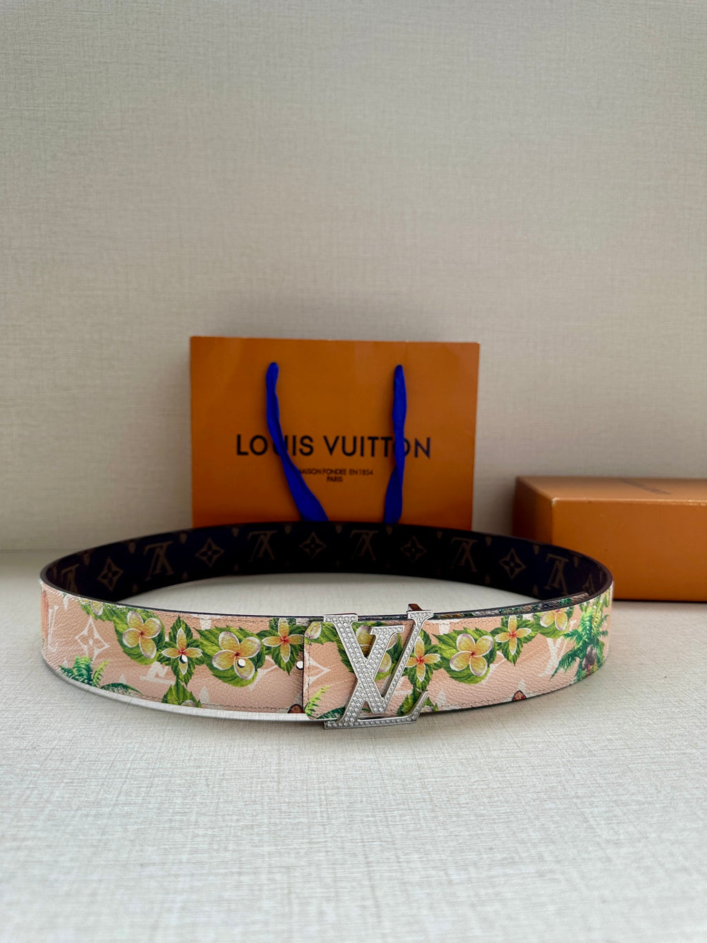Louis Vuitton belt with pink floral strap and silver LV buckle with engraved design