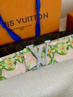 Louis Vuitton belt close-up: floral pink strap with silver LV buckle, glittery detail