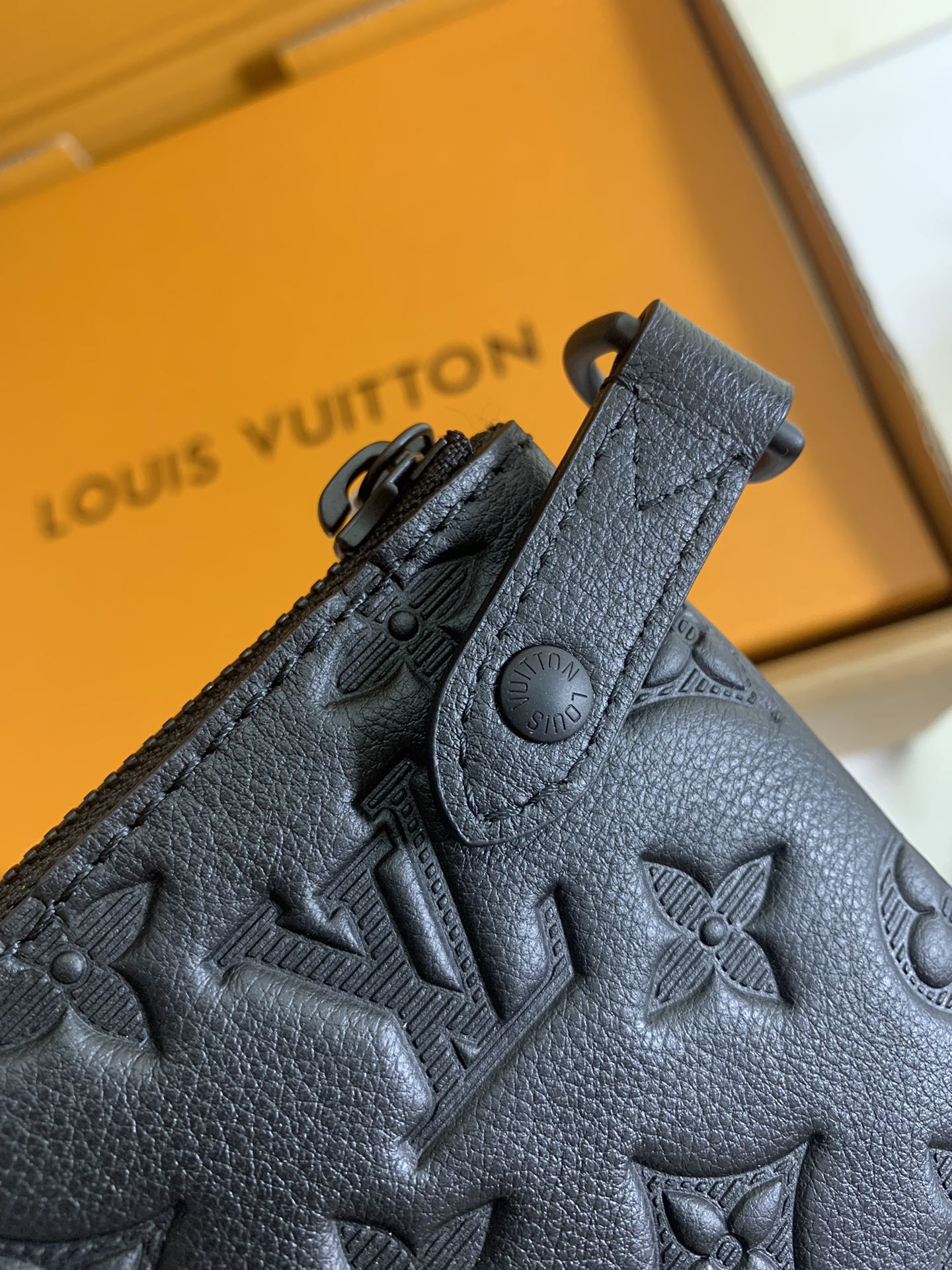 Louis Vuitton embossed monogram leather with snap and circular logo detail, dark gray