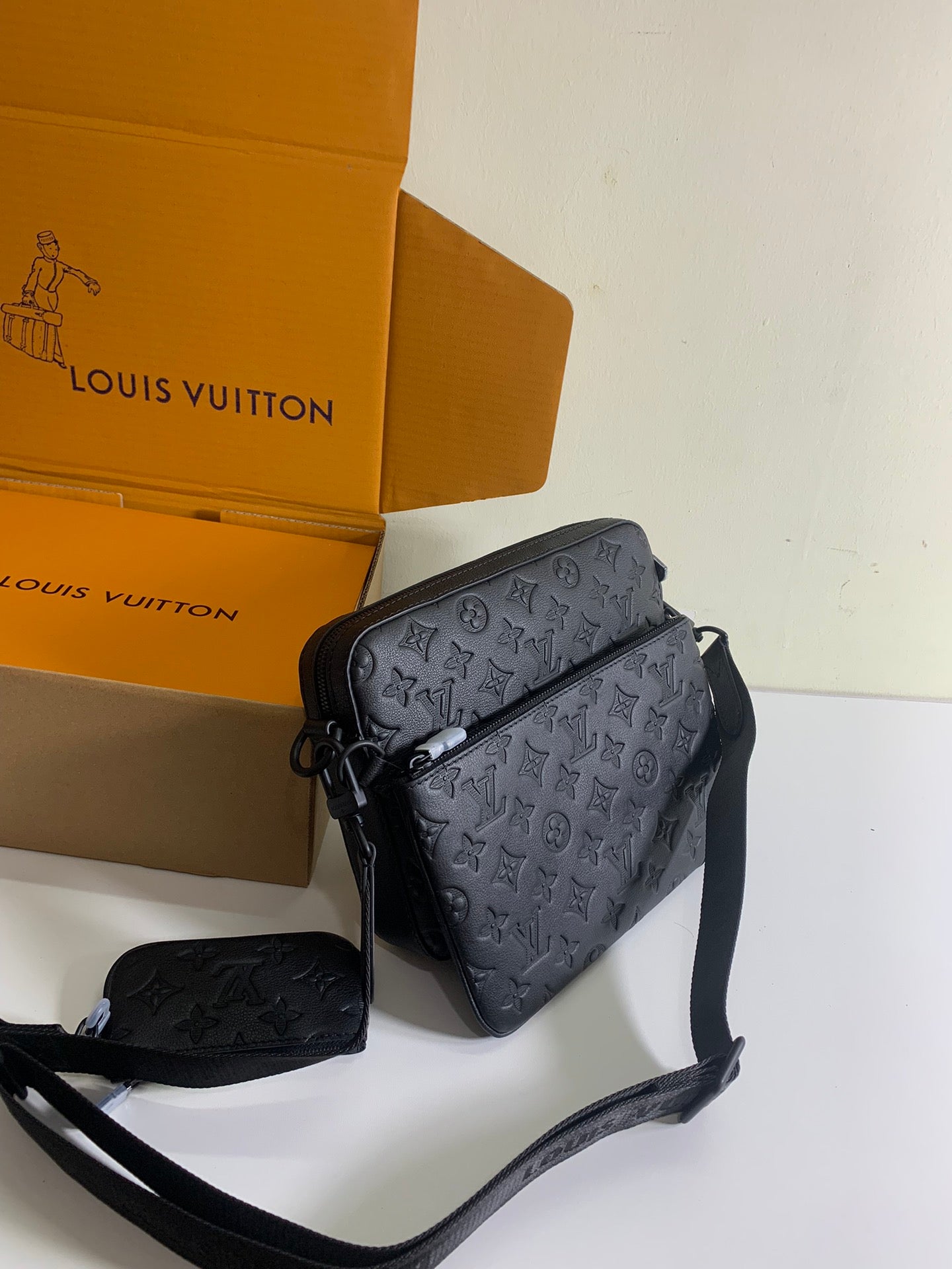 Louis Vuitton crossbody bag in dark monogram leather with adjustable strap, front view