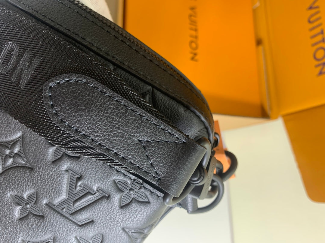 Louis Vuitton crossbody strap and dark monogram bag edge with visible stitching