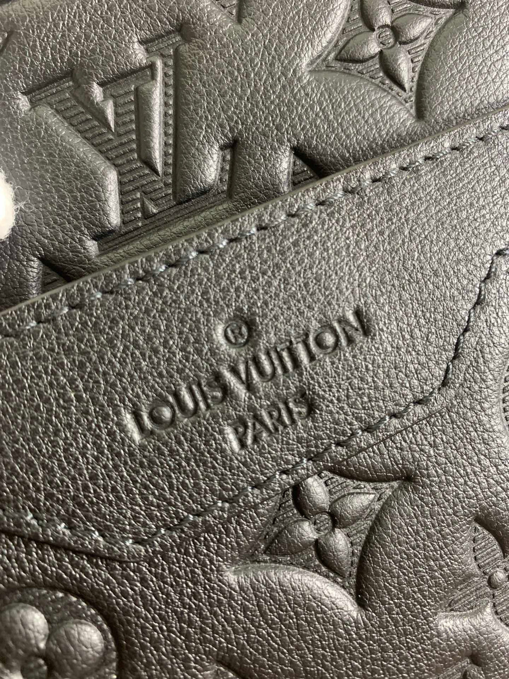 Louis Vuitton embossed monogram leather patch, dark grain and stitching detail