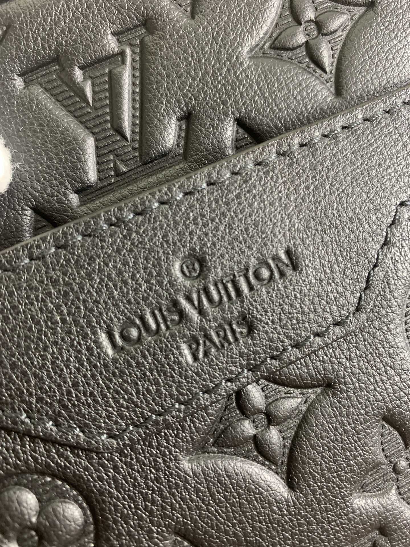 Louis Vuitton embossed monogram leather patch, dark grain and stitching detail