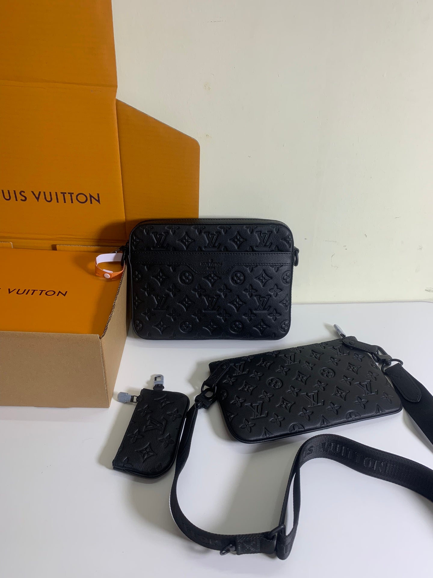 Louis Vuitton crossbody bag with dark monogram leather and matching mini pouch with strap.