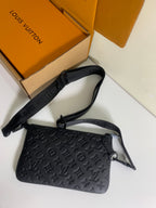 Louis Vuitton crossbody bag with dark embossed monogram pattern and adjustable shoulder strap.
