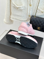 Pink Chanel sneakers sole view with chunky tread, on black display box