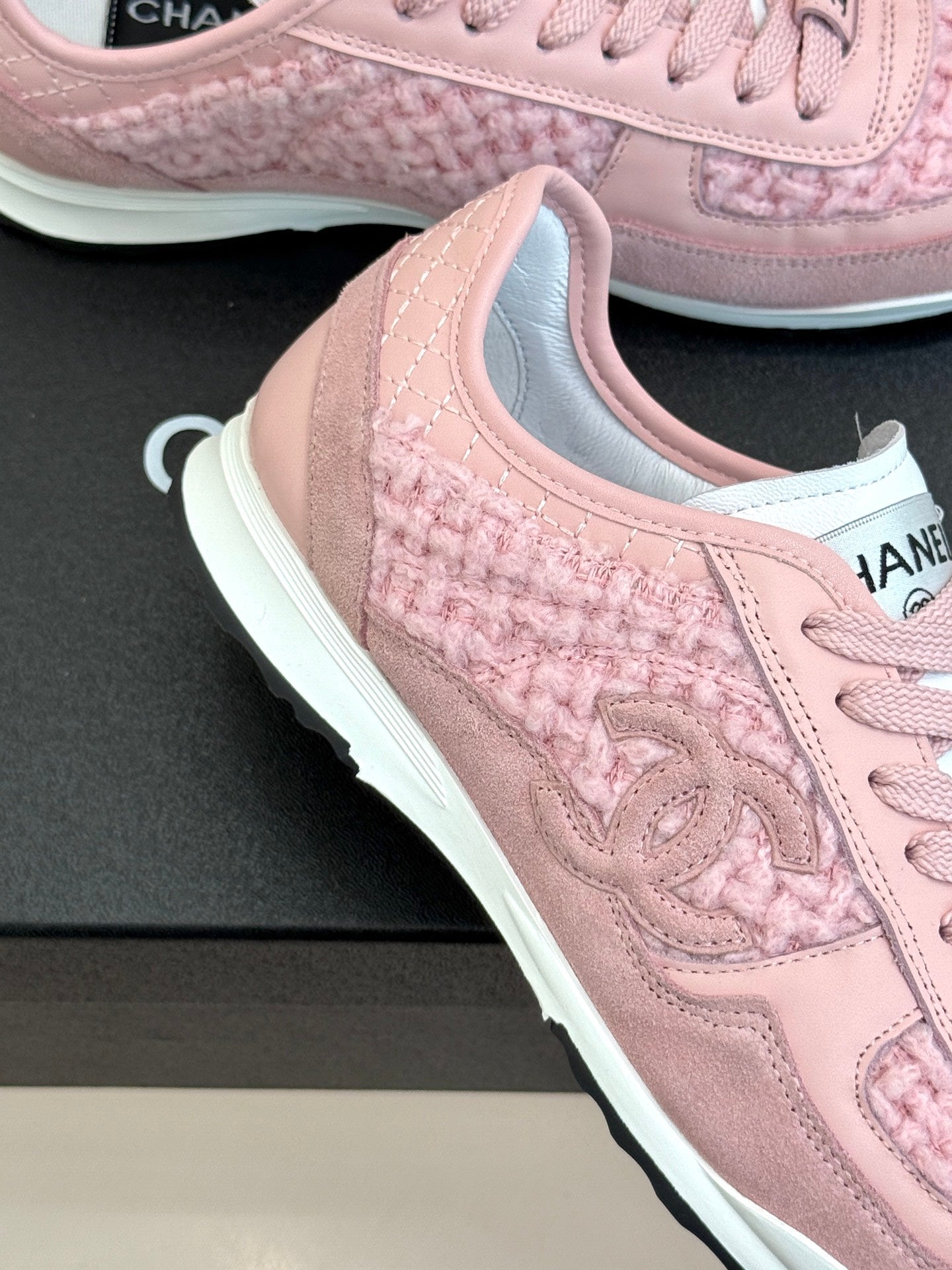Pink Chanel low-top sneakers close-up of side panel and lace-up area