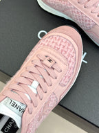 Pink Chanel sneakers close-up of toe cap and lace detail