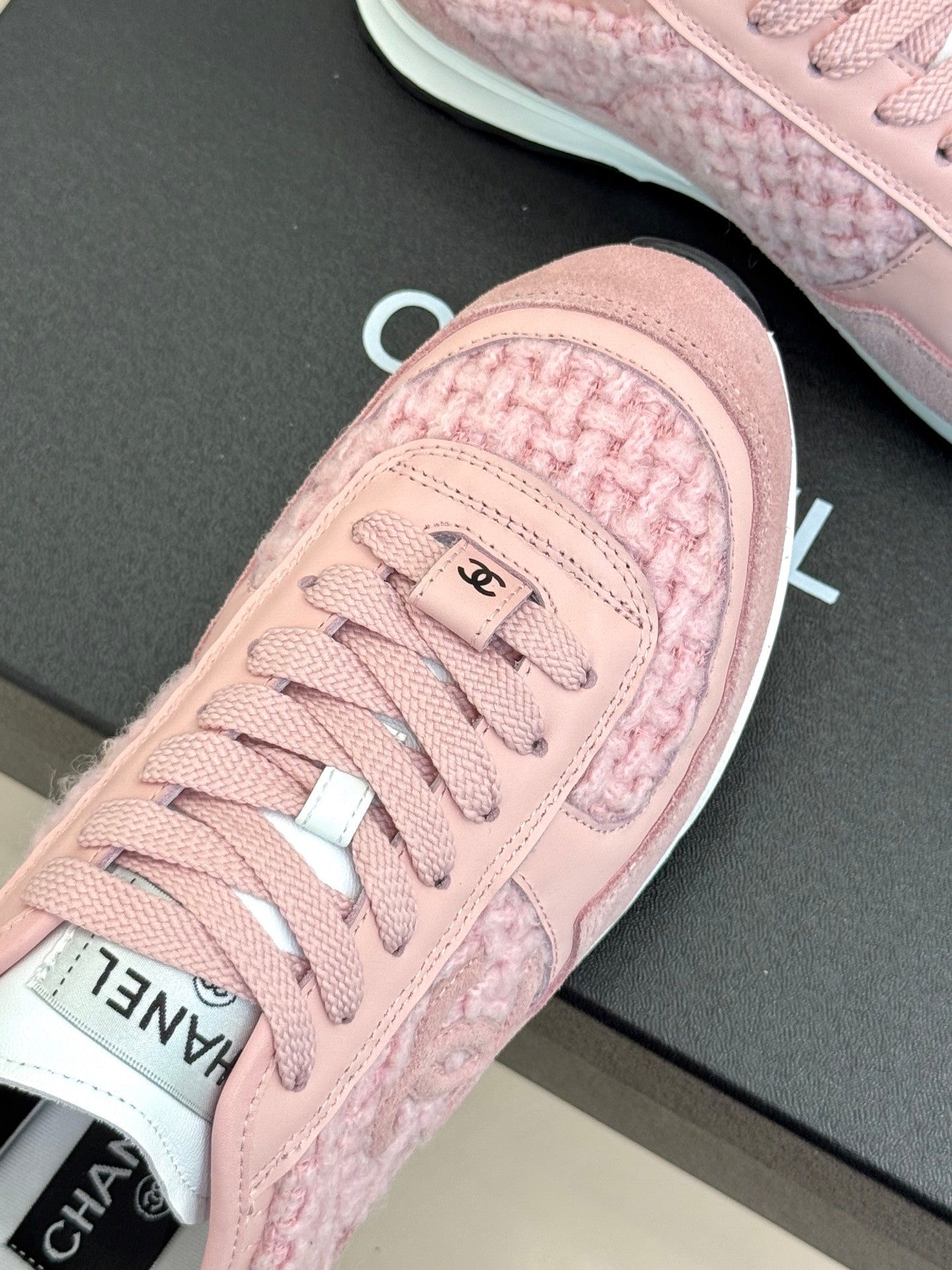 Pink Chanel sneakers close-up of toe cap and lace detail