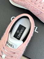 Pink Chanel sneaker close-up of tongue label and lace-up collar