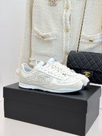 White Chanel low-top sneakers on box, textured fabric and lace-up front