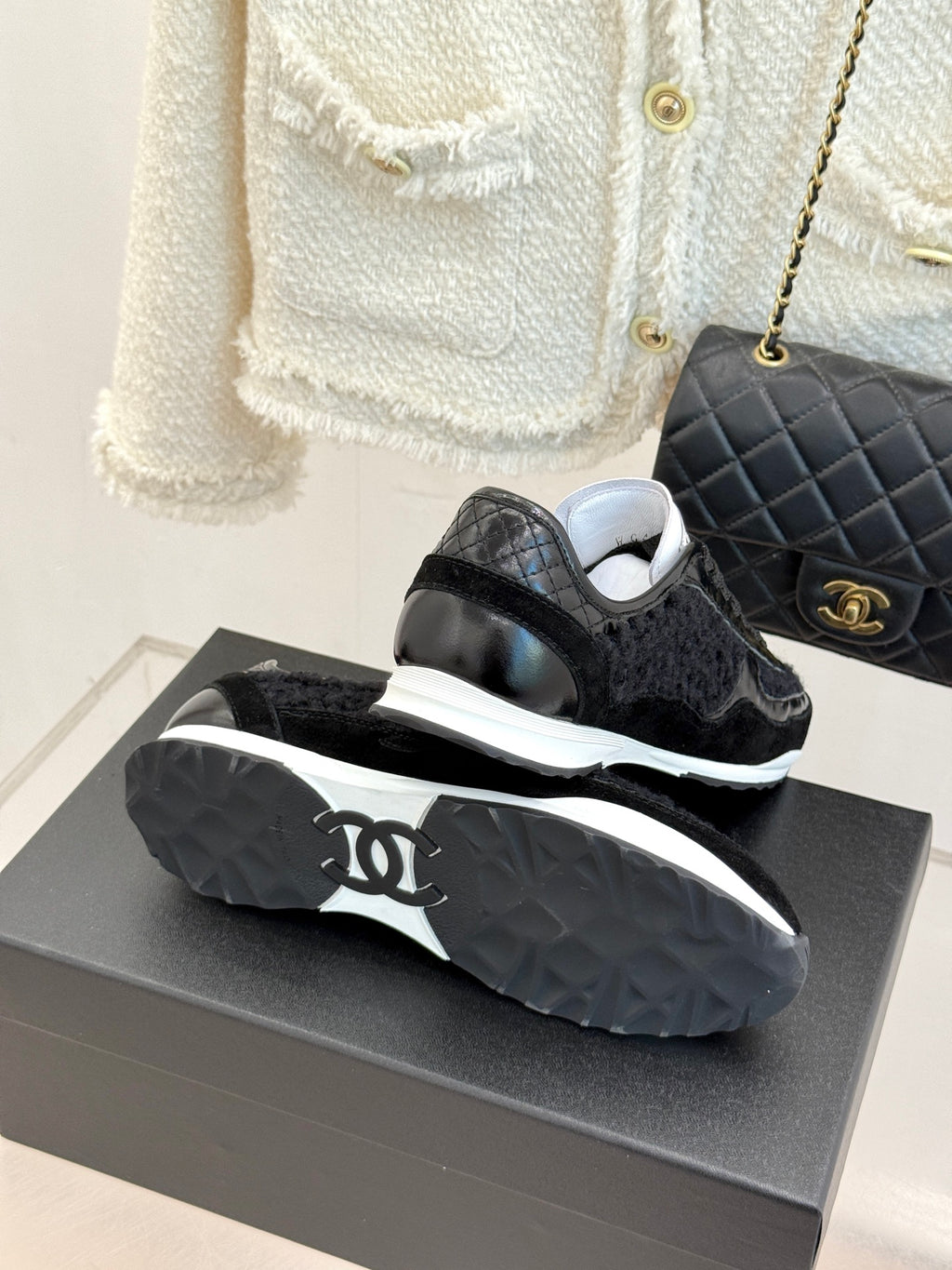 Chanel black sneakers with chunky sole and rear heel logo on shoe box
