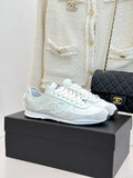 White Chanel sneakers with lace-up front and rubber sole