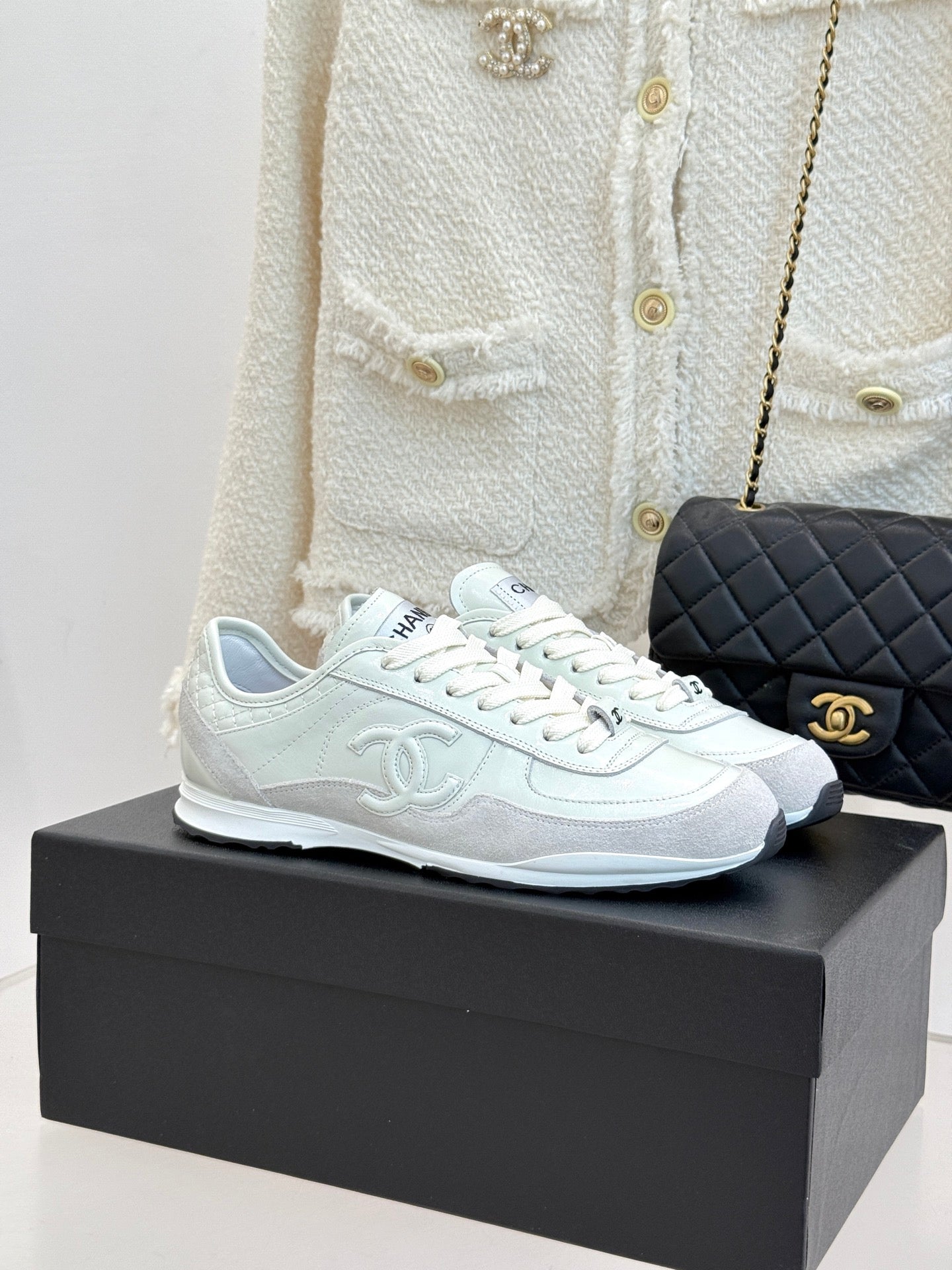 White Chanel sneakers with lace-up front and rubber sole