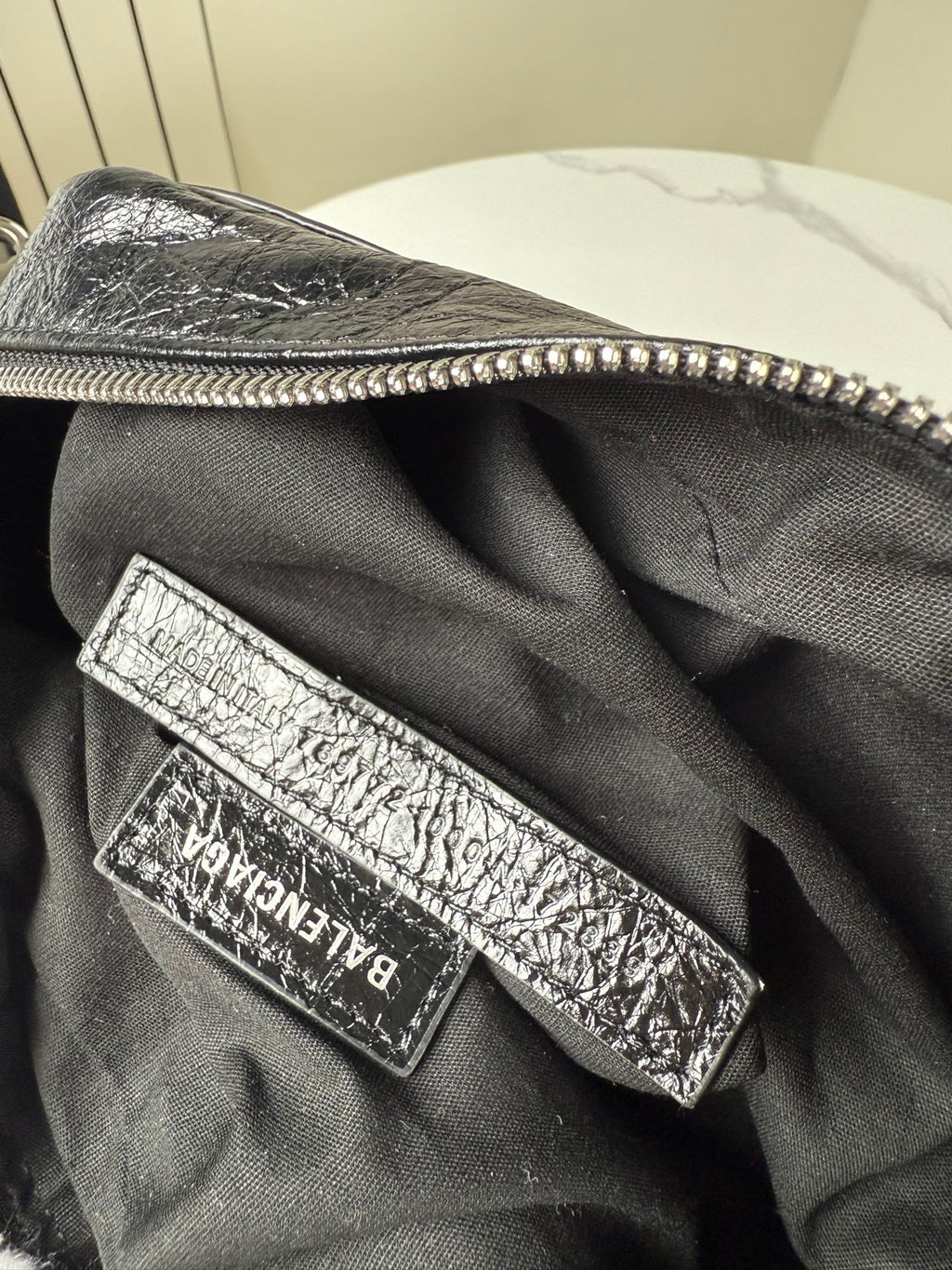 Balenciaga bag interior logo patch on black fabric lining