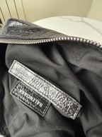 Balenciaga bag interior logo patch on black fabric lining