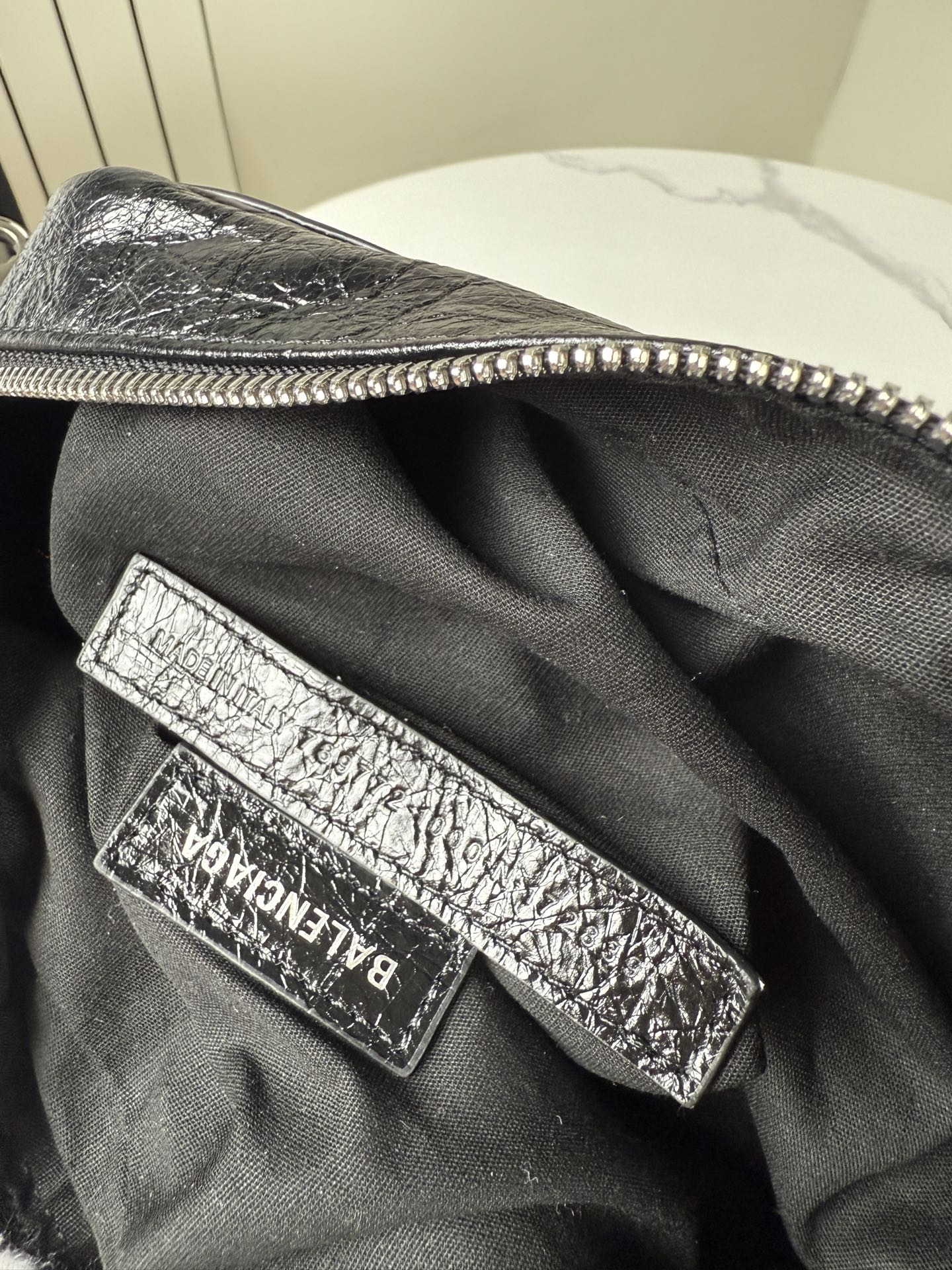 Balenciaga bag interior logo patch on black fabric lining