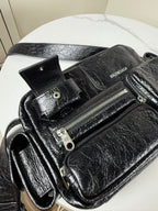 Balenciaga black leather crossbody bag with BALENCIAGA logo and zip pockets