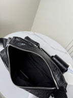 Balenciaga black leather bag interior with silver zipper and stitched edge