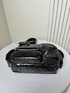 Balenciaga black leather bag with overlapping flap and multiple front details