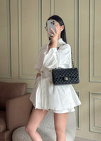 Chanel quilted flap shoulder bag in dark navy with chain strap on person