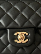 Chanel quilted flap bag front panel with gold CC logo on dark leather