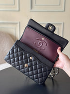 Chanel quilted bag with dark navy exterior and burgundy interior, chain strap