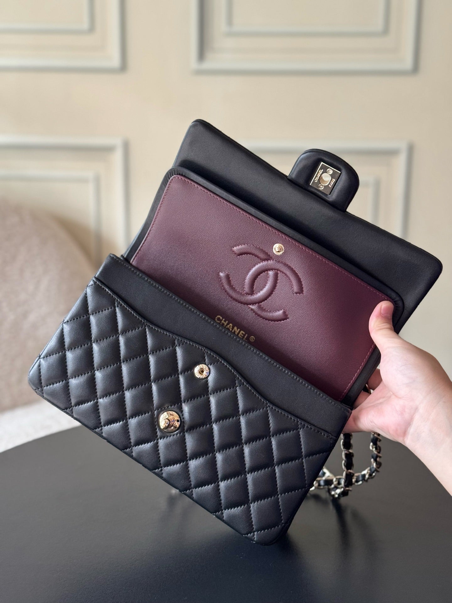 Chanel quilted bag with dark navy exterior and burgundy interior, chain strap