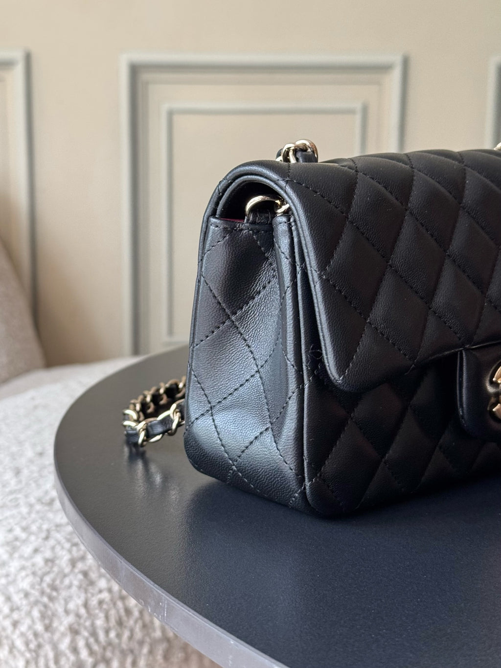 Chanel quilted leather shoulder bag with side view and gold chain connector