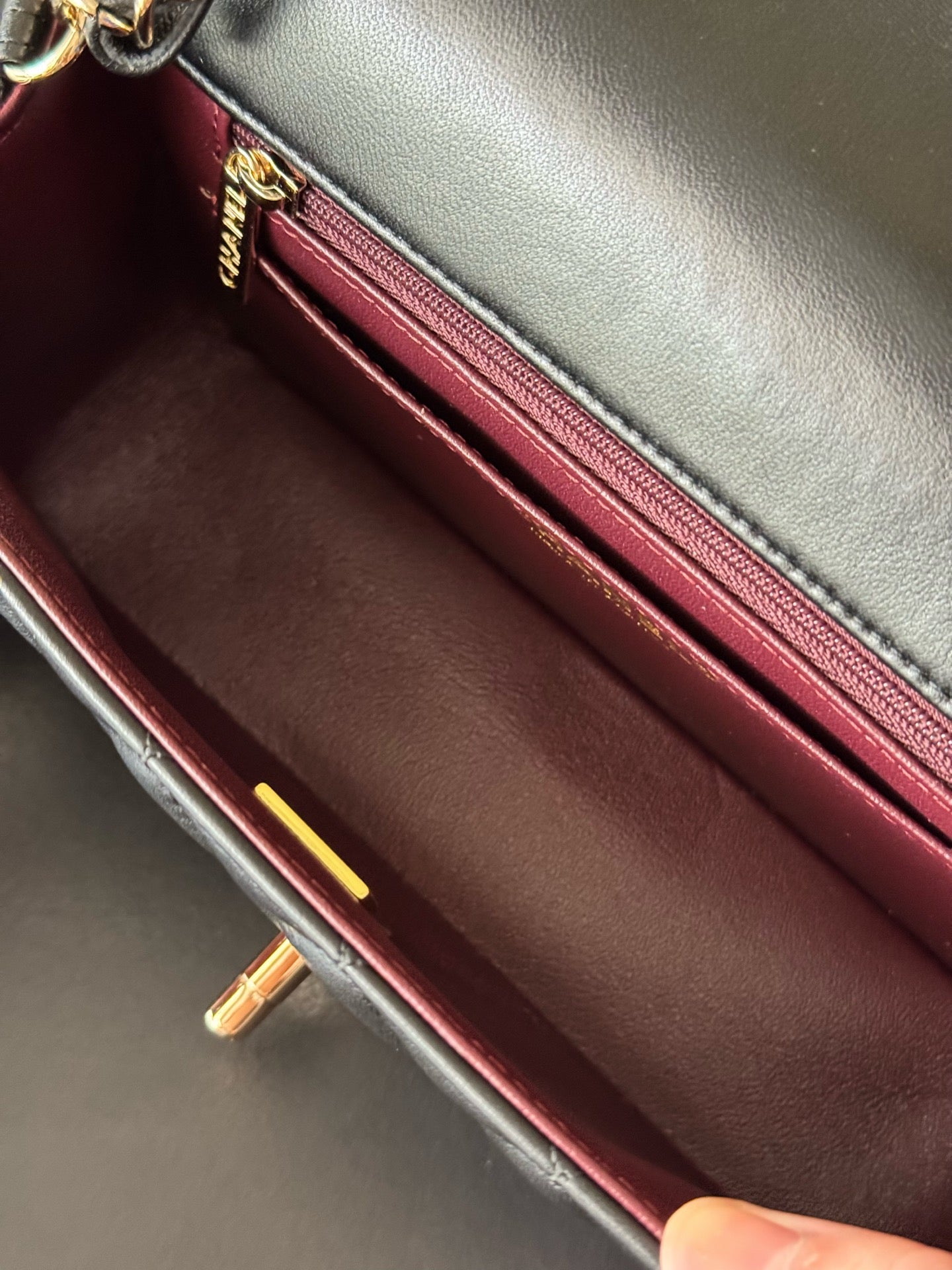 Chanel bag interior with red lining and metal zipper trim