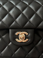 Black quilted Chanel flap bag with gold-tone CC logo centerpiece