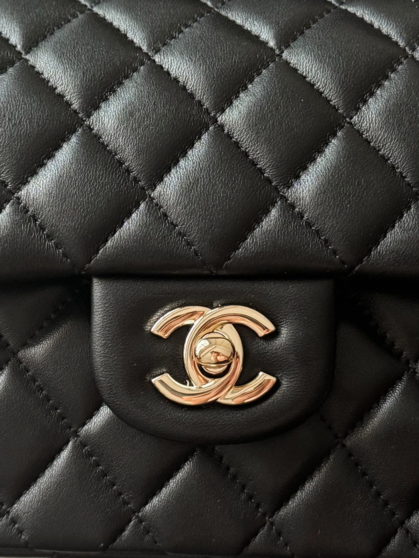 Black quilted Chanel flap bag with gold-tone CC logo centerpiece