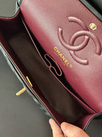 Maroon Chanel interior panel with embossed CC logo and engraved brand text
