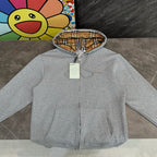 Gray hooded zip jacket with plaid-lined hood and front pockets