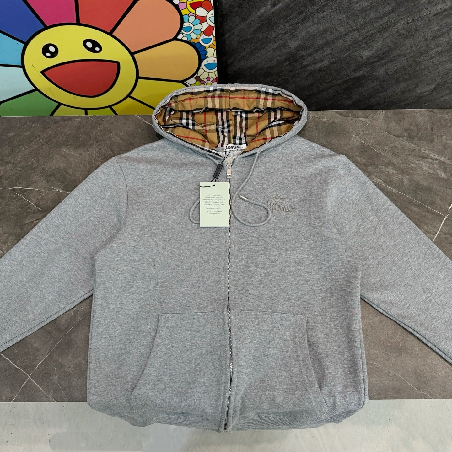 Gray hooded zip jacket with plaid-lined hood and front pockets