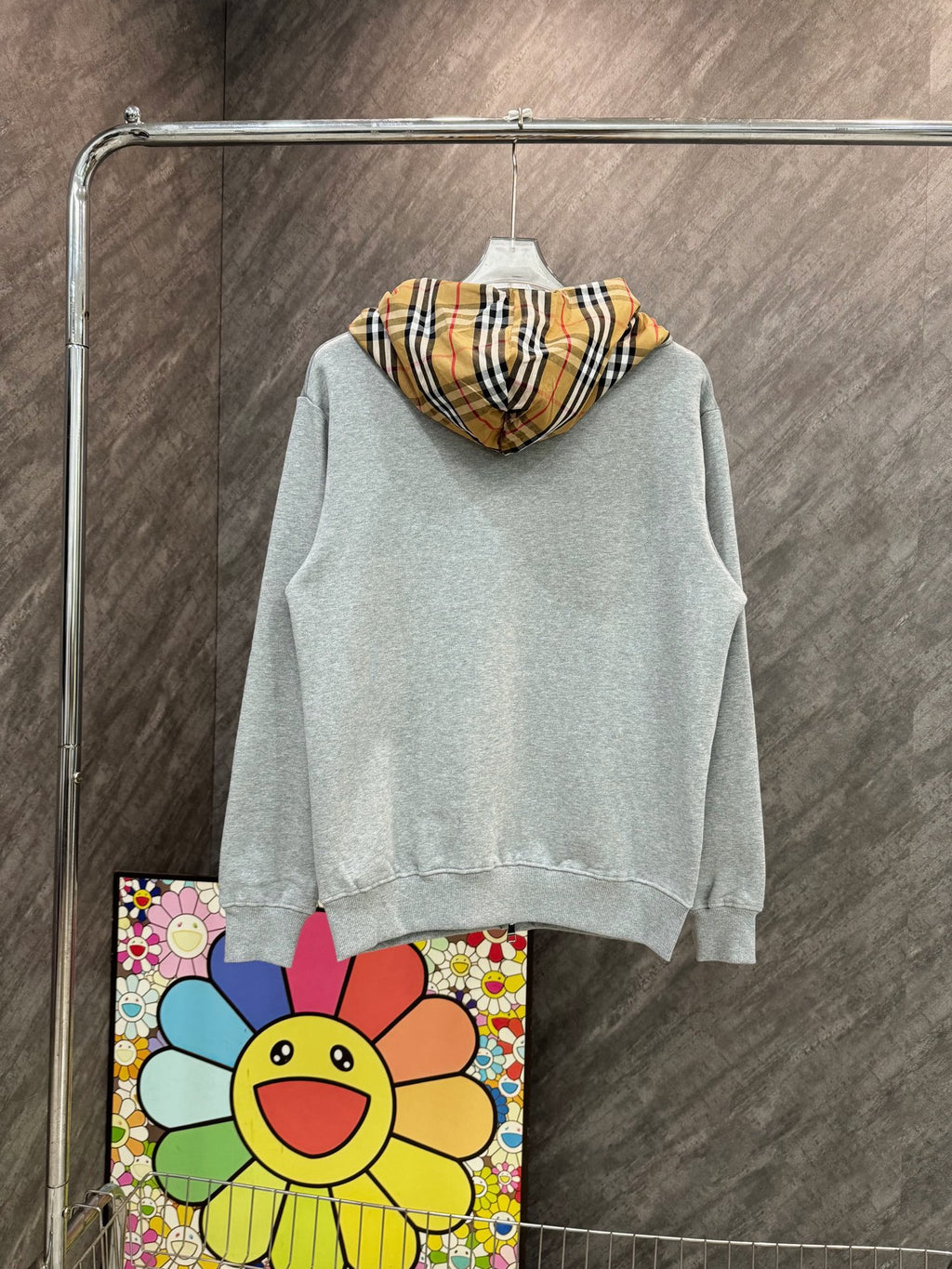 Light gray zip-up hoodie with drawstring hood and Burberry plaid lining