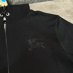Black zip-up hoodie close-up with Burberry horse logo on chest